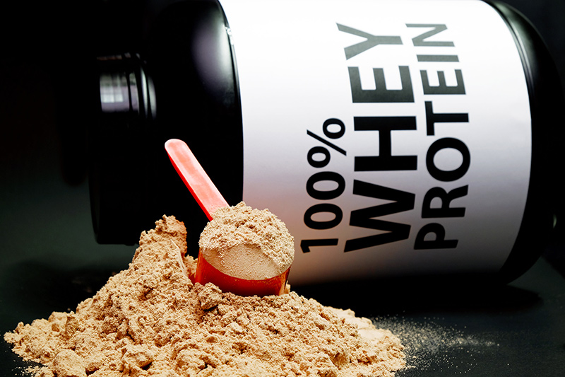 Whey Protein Powder in measuring scoop. รับผลิตเวย์โปรตีน